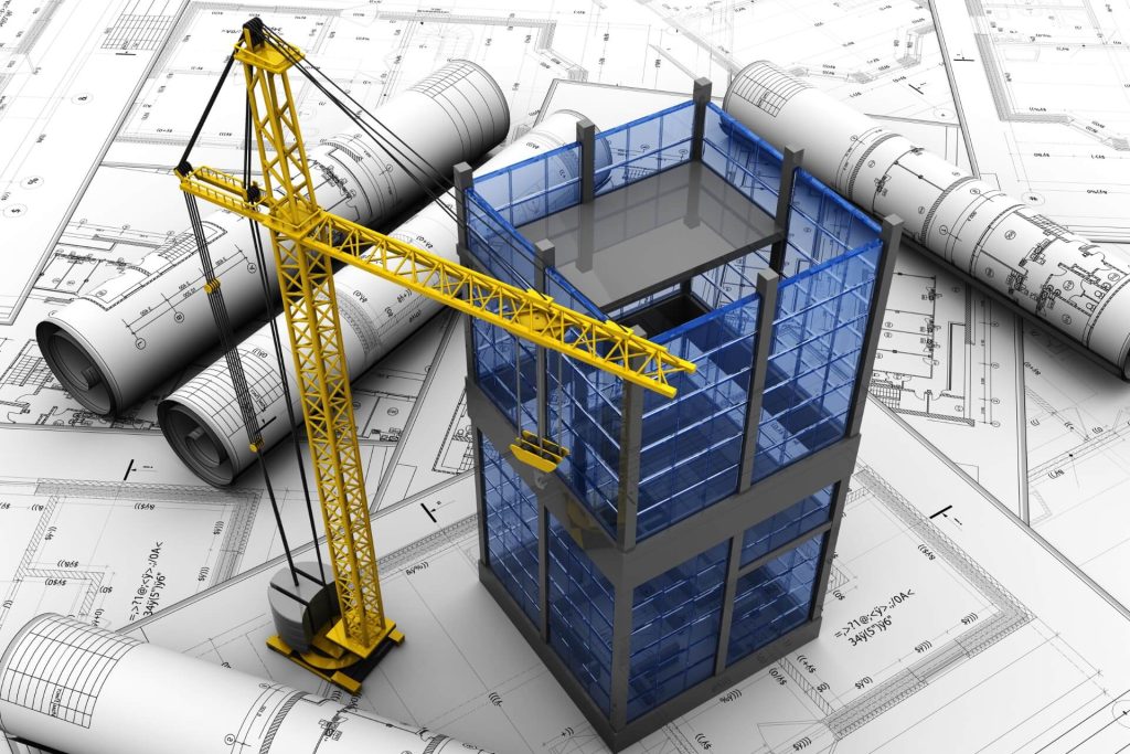 planos sobre un escritorio con una grúa y el modelo de un edificio